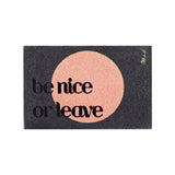 Doormat with 'be nice or leave' text on a black background